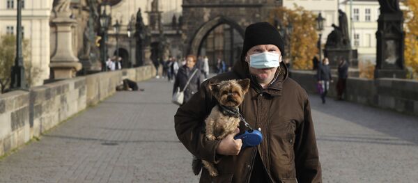 Мужчина в защитной медицинской маске на Карловом мосту в Праге, Чехия - Sputnik Узбекистан