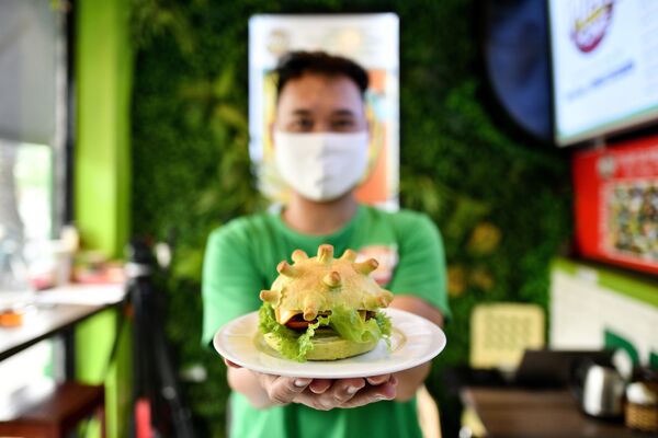 Владелец ресторана Pizza Home в Ханое позирует с гамбургером на тему коронавируса  - Sputnik Узбекистан