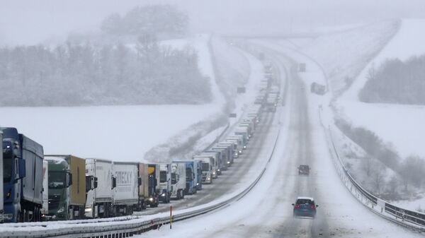 Gruzoviki na trasse vo vremya snegopada v Germanii - Sputnik O‘zbekiston