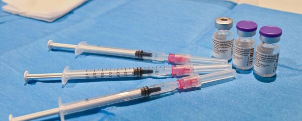 Шприцы и бутылочки с вакциной Pfizer - Sputnik Ўзбекистон