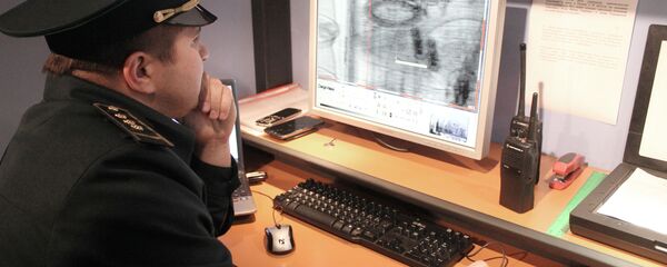 Работник таможенной службы проводит осмотр груза на экране монитора Работник таможенной службы проводит осмотр груза на экране монитора - Sputnik Узбекистан