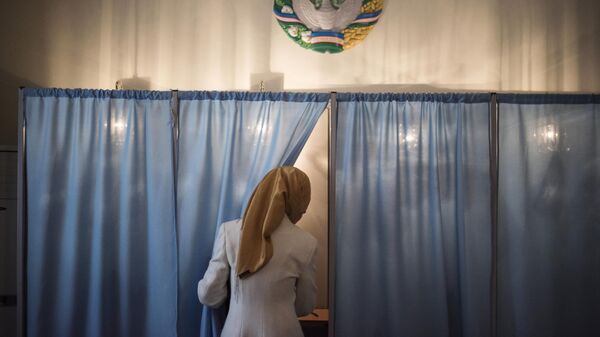 Женщина голосует на избирательном участке во время выборов президента Узбекистана. Архивное фото - Sputnik Узбекистан