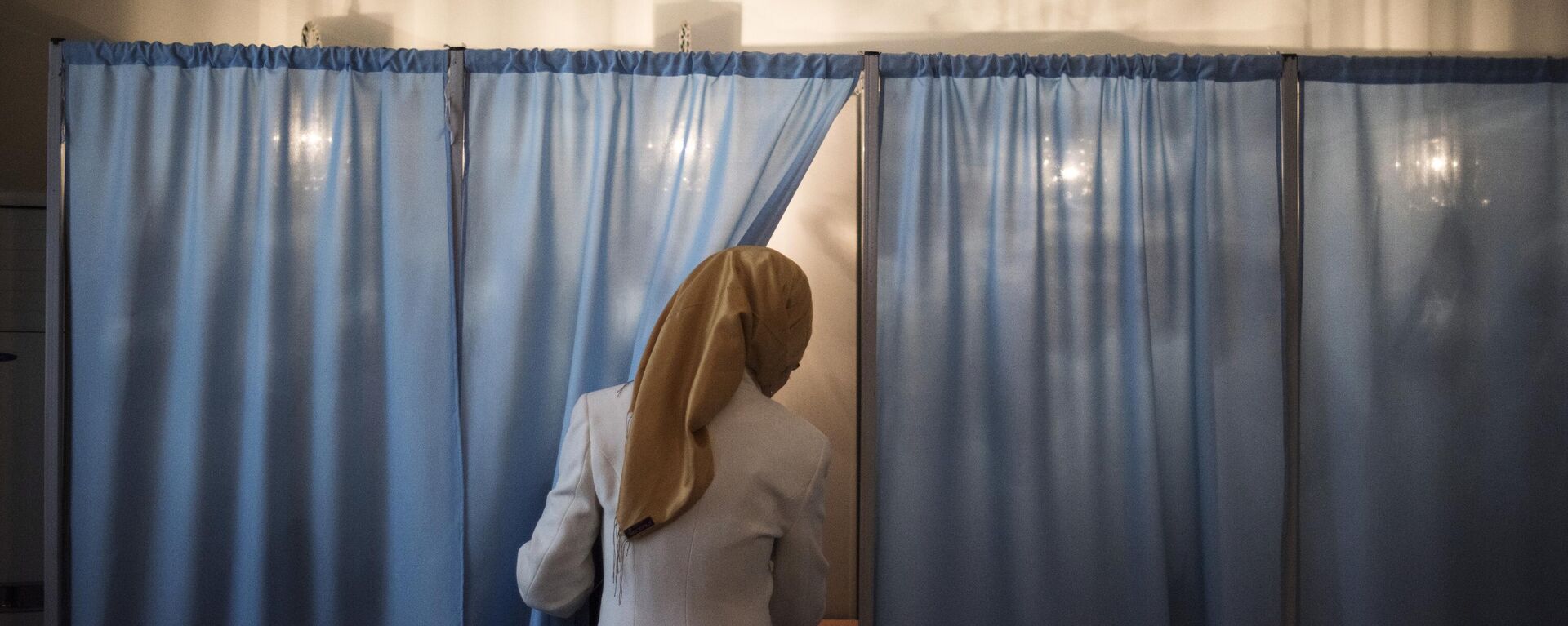 Женщина голосует на избирательном участке во время выборов президента Узбекистана. Архивное фото - Sputnik Узбекистан, 1920, 20.09.2021