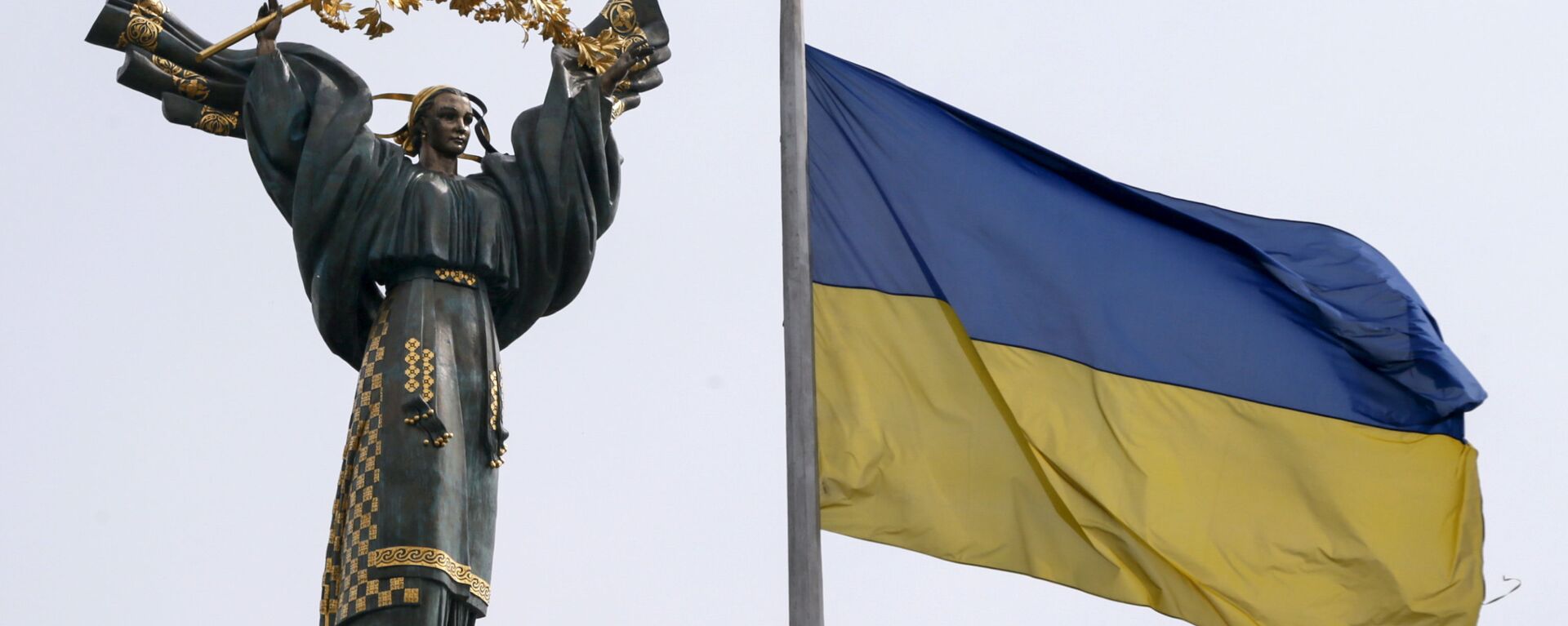 Флаг Украины на фоне Монумента Независимости на площади Независимости в Киеве - Sputnik Узбекистан, 1920, 23.08.2021