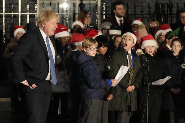 Премьер-министр Великобритании Борис Джонсон слушает детский хор на церемонии зажжения рождественских огней в Лондоне 1 декабря 2021 г. - Sputnik Узбекистан