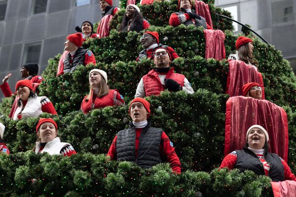 Хор исполняет рождественские гимны на гигантской поющей ёлке во время парада Macy&#x27;s в честь Дня благодарения в Нью-Йорке 25 ноября 2021 года. - Sputnik Узбекистан