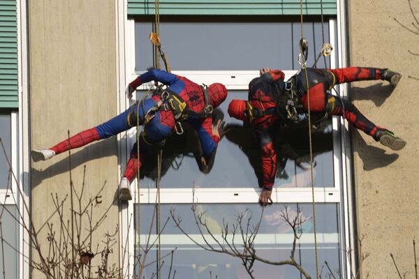 Команда акробатов, одетых в костюмы супергероев, спустилась на стропах с крыши больницы Сан-Паоло в Милане, Италия, 15 декабря, чтобы порадовать маленьких пациентов. - Sputnik Узбекистан