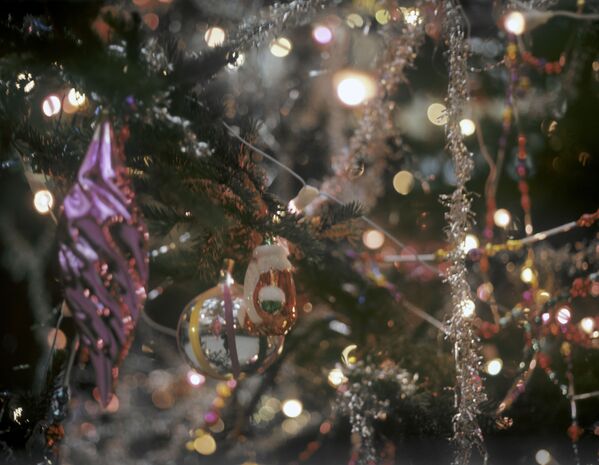 Новогодняя елка образца 1970-х: сосульки, домики с заснеженными крышами, первая пышная мишура из фольги. - Sputnik Узбекистан