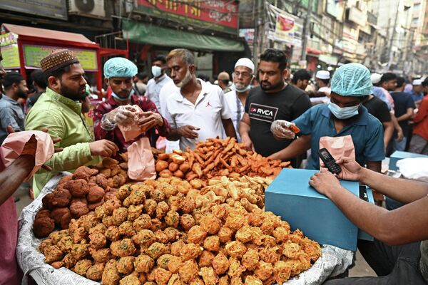 Верующие покупают фрукты, сладости и рис на уличном базаре в Дхакке, Бангладеш. - Sputnik Узбекистан