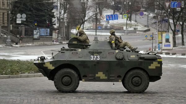 Украинские военнослужащие едут верхом на бронетранспортере в Киеве, Украина - Sputnik Узбекистан