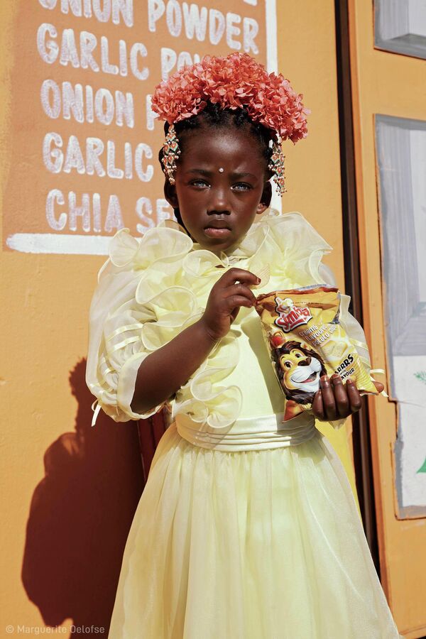 Снимок &quot;Девочка-цветок с пакетом чипсов&quot;  южноафриканского фотографа Marguerite Oelofse, победивший в регионе Южная Африка. - Sputnik Узбекистан