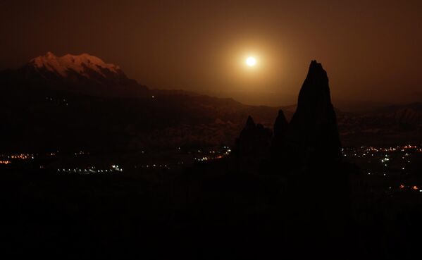 Полная луна восходит у заснеженной горы Иллимани, на окраине Ла-Паса, Боливия, вторник, 14 июня 2022 года. - Sputnik Узбекистан