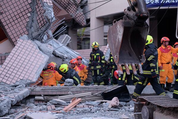 Спасатели разбирают завалы на месте разрушившегося здания.  - Sputnik Узбекистан