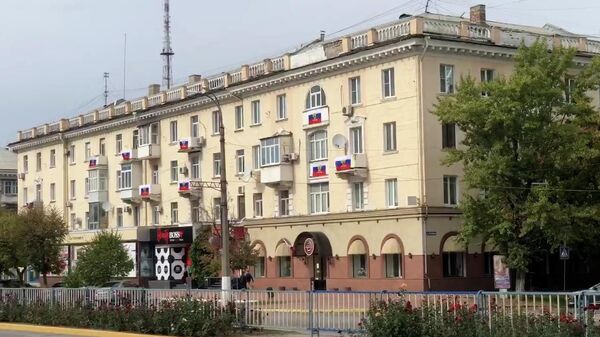 Российские флаги на балконах домов в Луганске в последний день референдума  - Sputnik Ўзбекистон