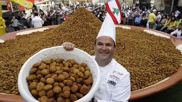Ливанский шеф-повар Рамзи Шуейр и ведерка жареных фалафельных шариковов в Бейруте 9 мая 2010 года - Sputnik Узбекистан
