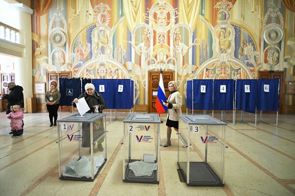Голосующие на выборах президента России на избирательном участке в Луганске - Sputnik Узбекистан