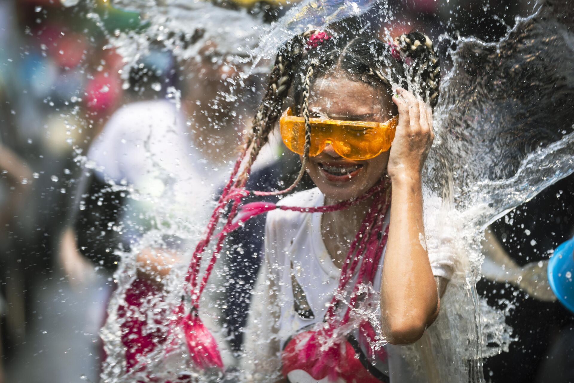 Vedro vodi oblivayetsya na jenshinu vo vremya vodnogo festivalya Songkran v chest tayskogo Novogo goda v provinsii Prachinburi, Tailand - Sputnik O‘zbekiston, 1920, 18.12.2024