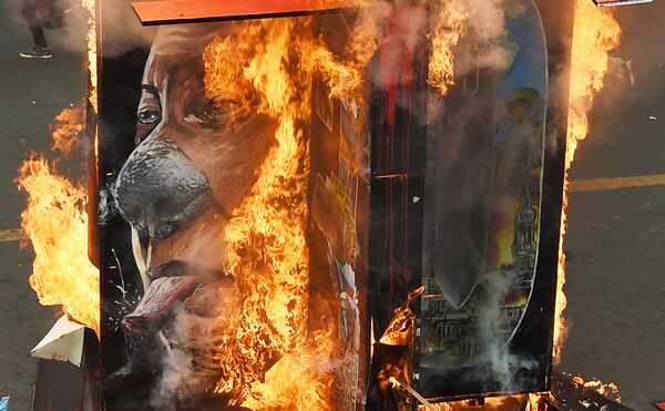 Горящий портрет президента Филиппин Родриго Дутерте на митинге в в Маниле - Sputnik Узбекистан