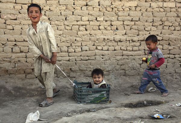 Мальчик катает младшего брата в корзине из-под овощей, окраина Кабула, Афганистан, 2018 год. - Sputnik Ўзбекистон