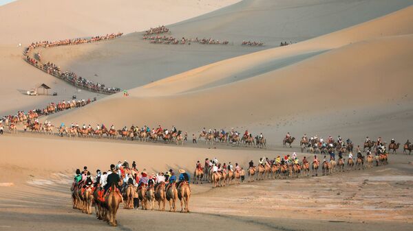 Туристы на верблюдах в пустыне в Дуньхуане, Китай - Sputnik Ўзбекистон