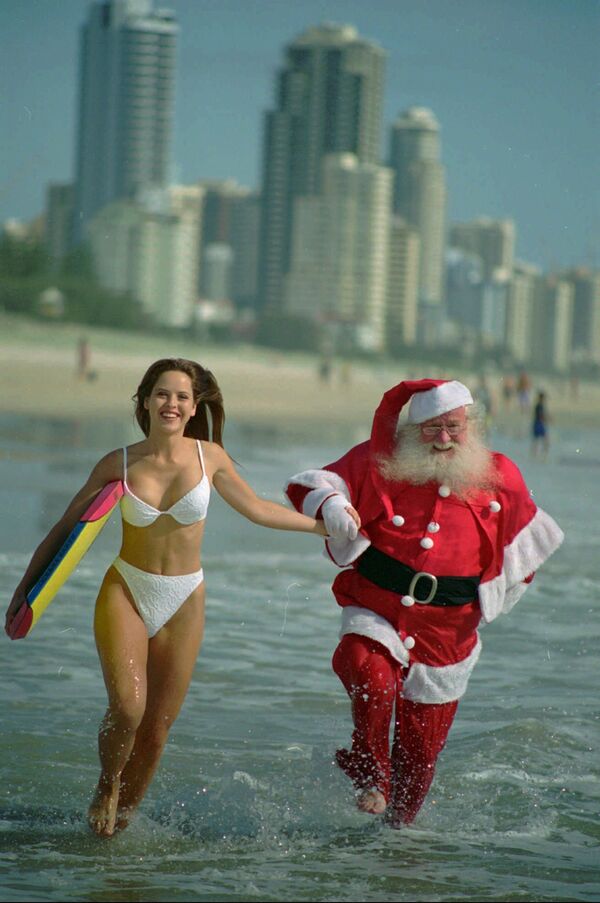 Австралийка и Санта-Клаус на пляже в Квинсленде, Австралия - Sputnik Узбекистан