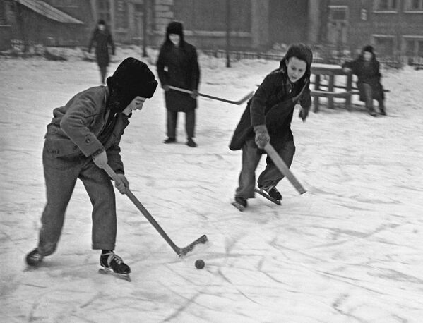 Дети играют в хоккей во дворе, 1959 год - Sputnik Узбекистан