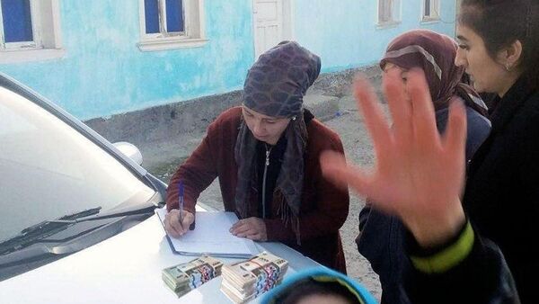 Женщина подписывает документ на капоте автомобиля - Sputnik Ўзбекистон