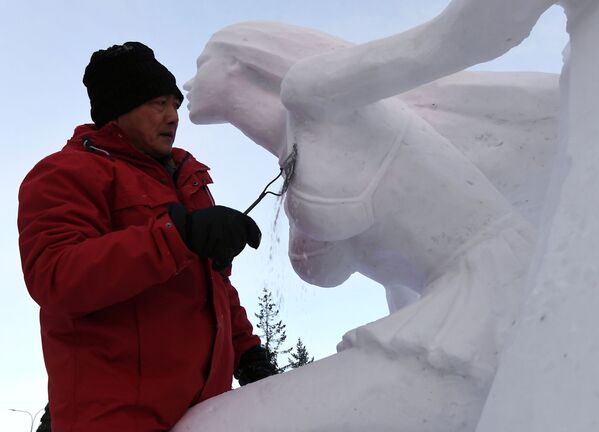 Победитель в номинации Снег работает над снежной скульптурой на VIII ежегодном международном фестивале-конкурсе снежной и ледовой скульптуры Волшебный лед Сибири - Sputnik Узбекистан