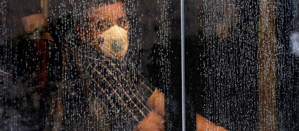 Житель в маске в автобусе в Тегеране  Житель в маске в автобусе в Тегеране  - Sputnik Ўзбекистон