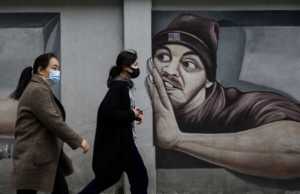 Девушки в масках напротив граффити в Ухане  - Sputnik Узбекистан