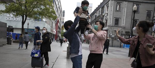 Жители гуляют на улице Уханя - Sputnik Ўзбекистон