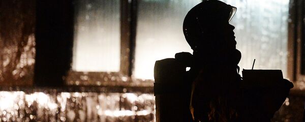 Сотрудник МЧС России во время тушения пожара Сотрудник МЧС России во время тушения пожара - Sputnik Узбекистан