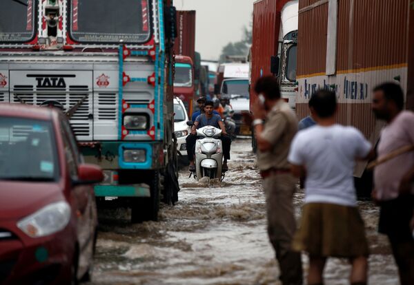 Полузатопленное шоссе после обильных дождей на окраине Нью-Дели, Индия - Sputnik Узбекистан