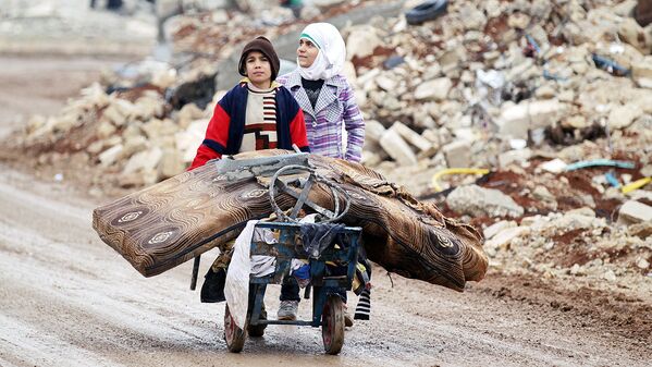 Мальчик и девочка перевозят вещи в районе северного Алеппо - Sputnik Узбекистан