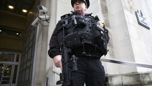 An armed police officer stands guard outside of the Ministry of Defence in London, Britain November 18, 2015 - Sputnik Узбекистан