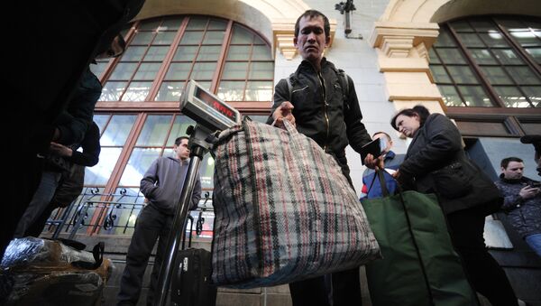 Пассажиры поезда Москва – Душанбе взвешивают багаж на перроне Казанского вокзала - Sputnik Узбекистан