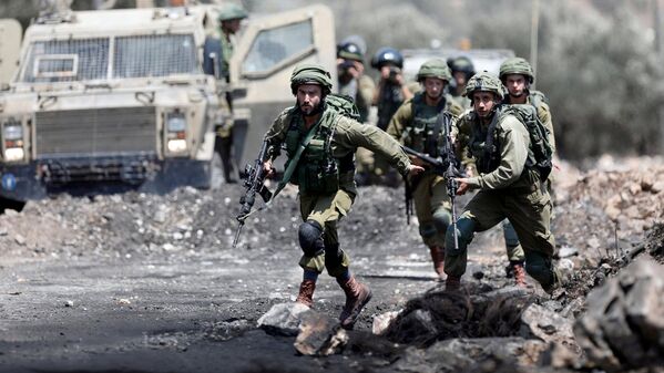 Israeli soldiers run during clashes with Palestinian protesters in the West Bank village of Kofr Qadom near Nablus - Sputnik Узбекистан