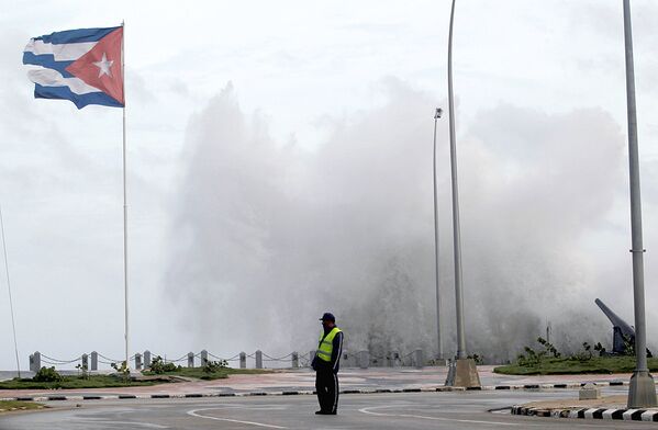 Полицейский стоит на набережной Эль-Малекон в Гаване перед ураганом Ирма - Sputnik Узбекистан