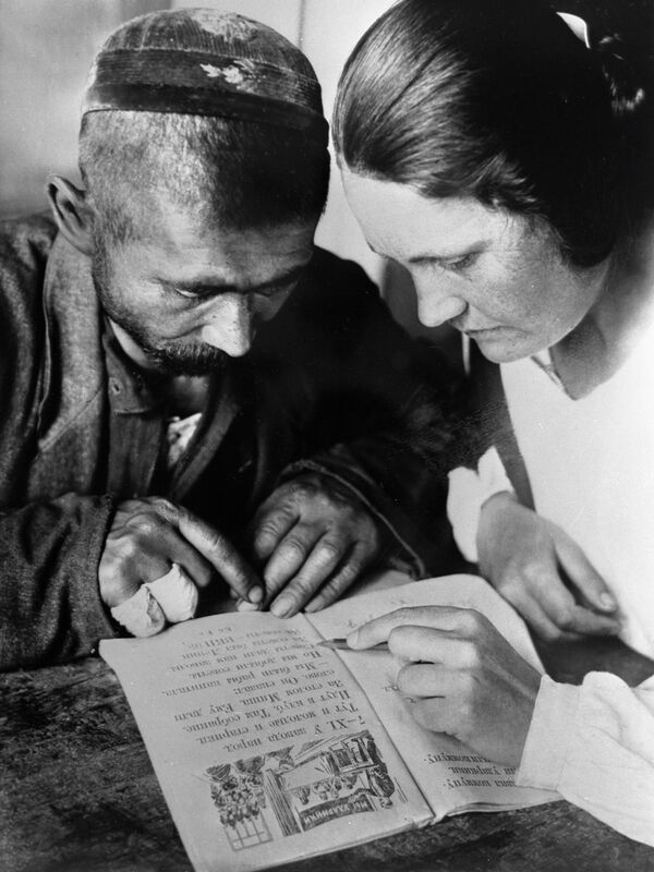 Студентка педагогического факультета обучает грамоте рабочего литейного цеха Ташкентского завода Мирзу Мухамедова. Узбекская ССР. Студентка педагогического факультета обучает грамоте рабочего литейного цеха Ташкентского завода Мирзу Мухамедова. Узбекская ССР. - Sputnik Узбекистан