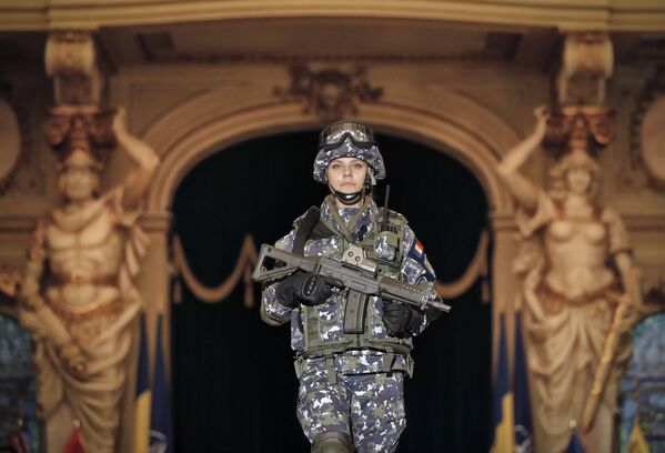 Женщина в румынских вооруженных силах демонстрирует на показе будущую боевую униформу в Центральном армейском доме в Бухаресте. - Sputnik Узбекистан