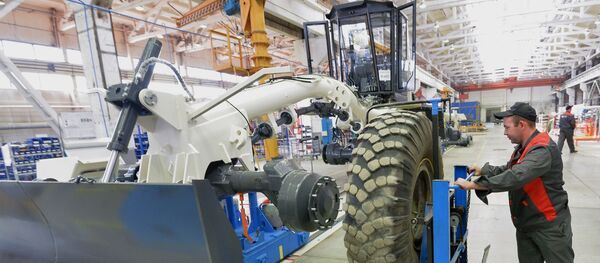 Рабочий на линии сборки на заводе по производству строительной техники Рабочий на линии сборки на заводе по производству строительной техники - Sputnik Узбекистан